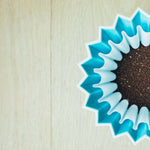 Luna Nueva specialty-grade Mexican coffee grounds in a blue filter for drip brew.