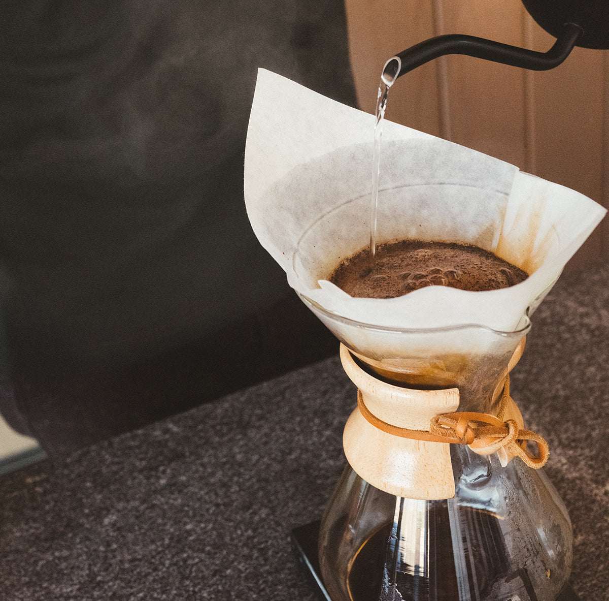 Hypnos decaf coffee brewing in a pour-over with a paper filter and hot water stream